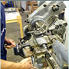Turning by hand a sleeve and rod mounting solution, seen here on a small lath can also be computerised using CNC machines which can produce multiples, if for example there are a series of objects that need to use exactly the same sleeve and rod system of mounting / mount  making.